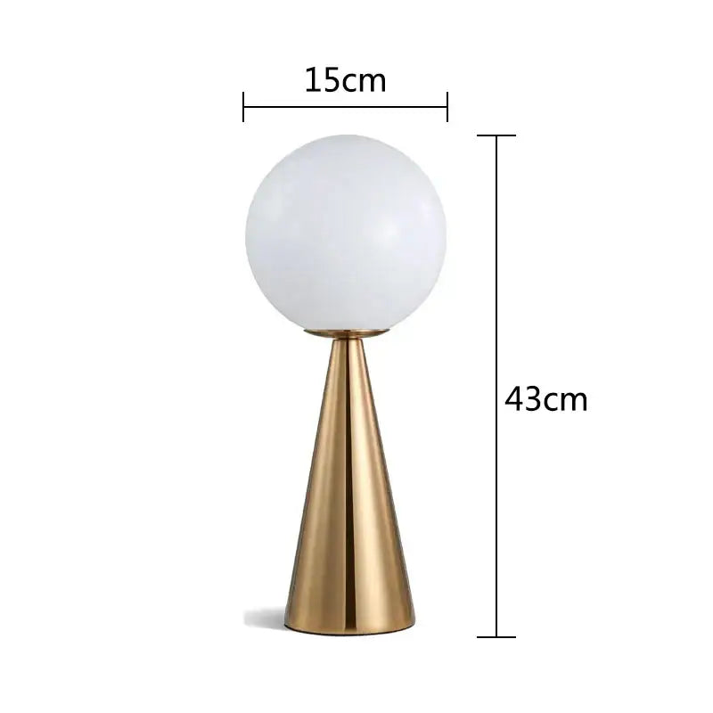 A sleek gold-toned cone glass table lamp with frosted globe shade for modern bedroom decorbites cone glass lighting
