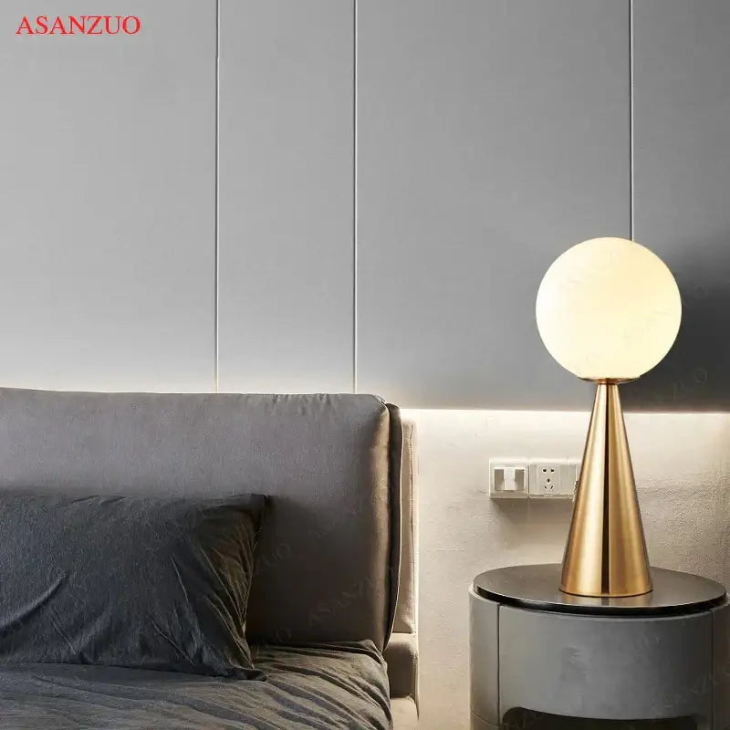 Modern gold cone glass table lamp with frosted globe light and gold-toned conical base for bedroom decorbites cone glass