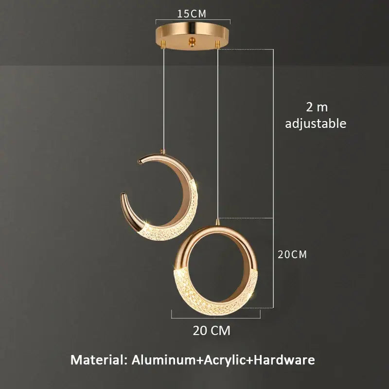 Modern gold pendant light with crescent and circular design featuring sparkling acrylic accents for dining settings