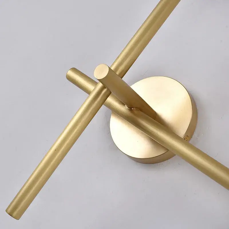 Modern gold cross-shaped wall lamp with brass finish and intersecting cylindrical arms for stylish living room decorbites cross-shaped wall lamp