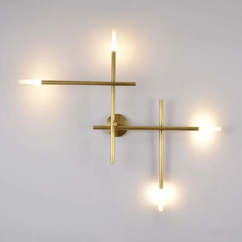 Modern brass wall lamp with three illuminated arms in a geometric cross-shaped wall lamp for living room decorbites decor