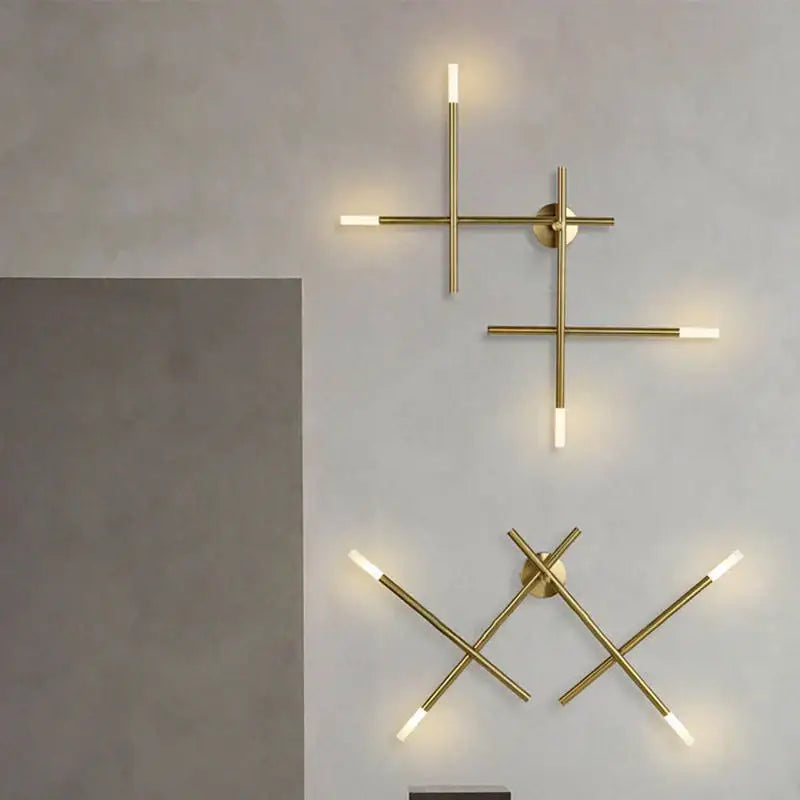 Modern gold cross-shaped wall lamp with intersecting cylindrical arms and frosted led ends for elegant wall decorbites cross-shaped wall lamp