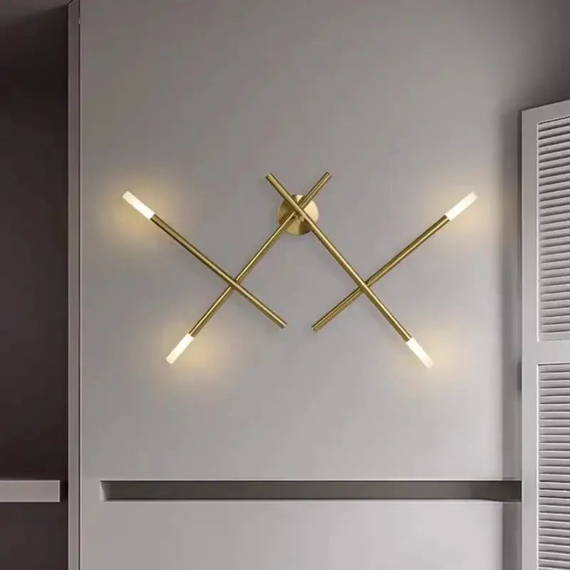 Modern gold cross-shaped wall lamp with four illuminated intersecting rods for stylish living room decorbites wall lamp
