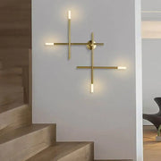 Modern gold-toned cross-shaped wall lamp with minimalist design and frosted glass accents for living room decorbites wall lamp