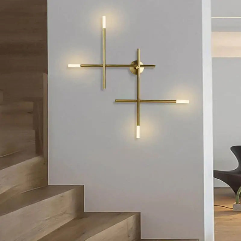 Modern gold-toned cross-shaped wall lamp with minimalist design and frosted glass accents for living room decorbites wall lamp