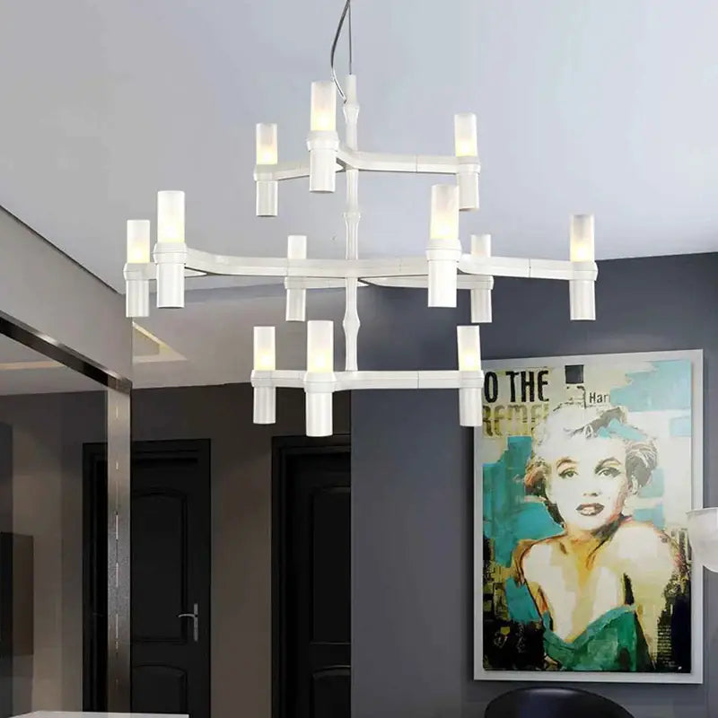 Modern gold decorbites crown major chandelier with geometric multi-tiered design and white cylindrical glass lights for foyer decor