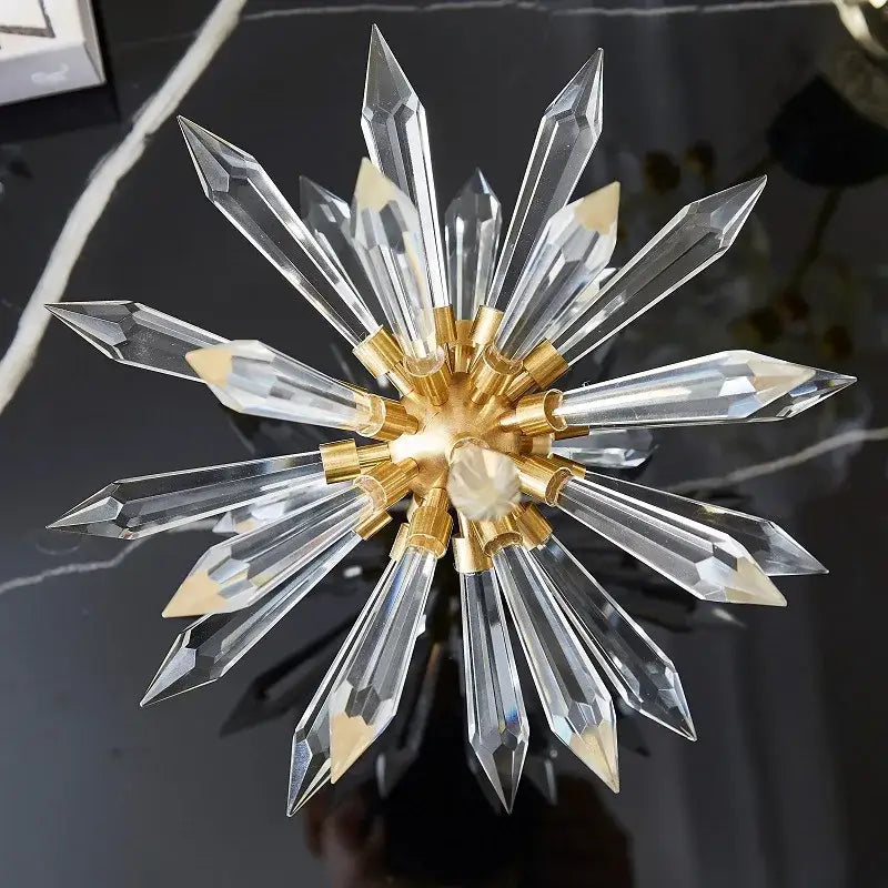 A modern gold crystal ball acanthosphere starburst chandelier with clear faceted crystal arms for home decoration