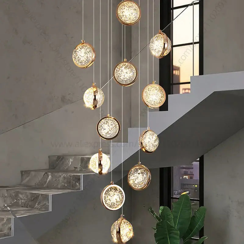 Modern gold crystal ball chandelier with spherical pendant lights and crackled glass interiors for staircase hanging