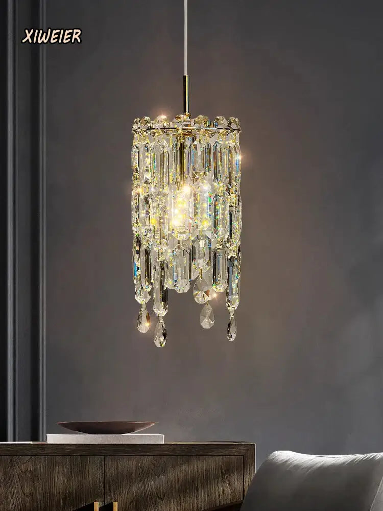 Modern gold crystal bedhead pendant light with sparkling gold-toned chandelier and clear glass prisms decorbites crystal bedhead