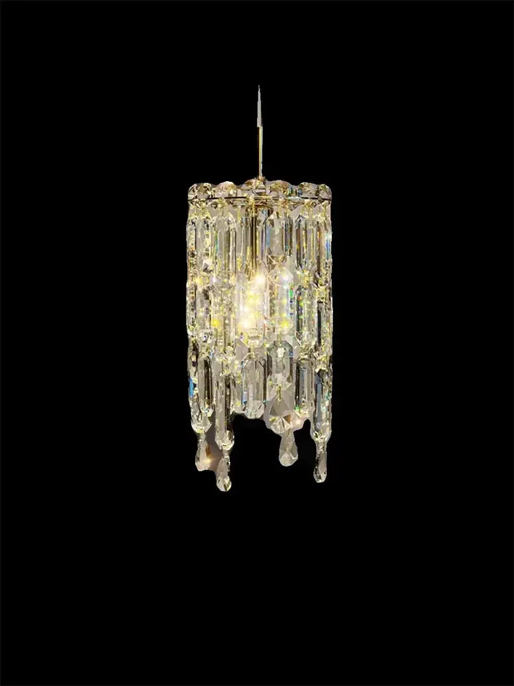 A modern gold crystal bedhead pendant light featuring a sparkling gold-toned chandelier with faceted glass prisms