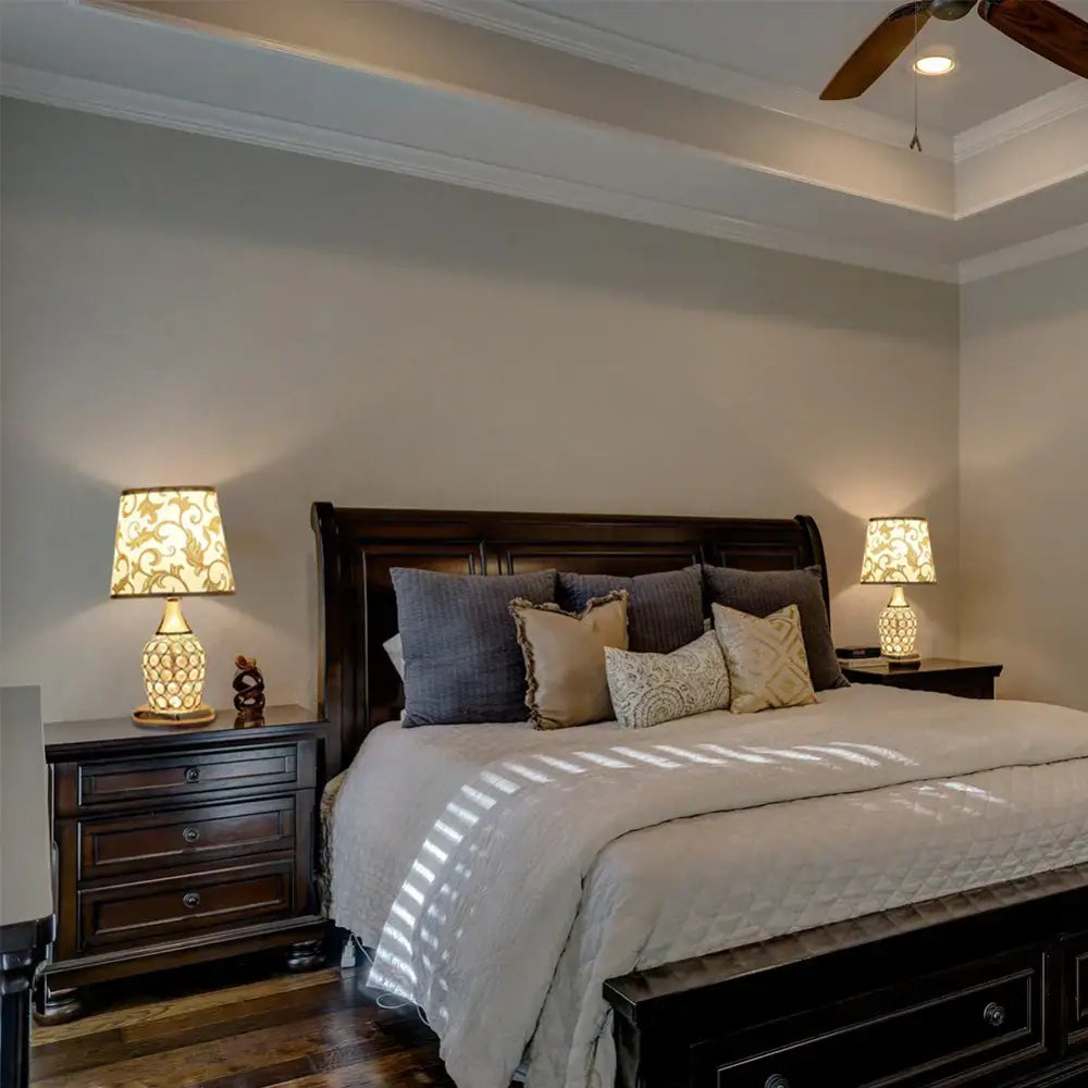 Modern gold crystal bedroom table lamp with lace shade displayed on dark wood sleigh bed with quilted white comforter and pillows decorbites crystal bedroom crystal bedroom table