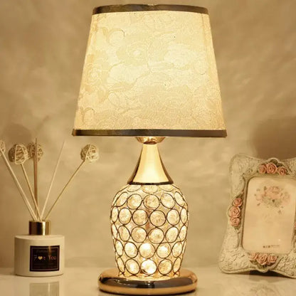 Modern gold crystal bedroom table lamp with a gold-toned base and off-white lace-patterned shade for decorbites crystal bedroom decor