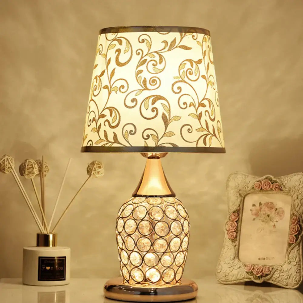 Elegant modern gold crystal bedroom table lamp with a cream lace shade and a crystal-encrusted glowing base for decorbites crystal bedroom decor