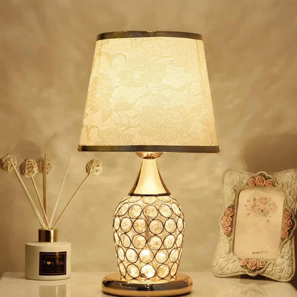 Modern gold crystal bedroom table lamp with a crystal-encrusted base and cream lace-patterned shade for decorbites crystal bedroom decor