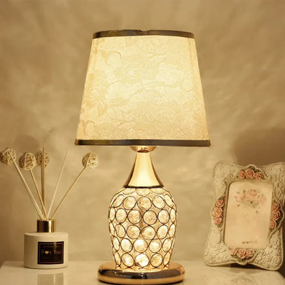 Modern gold crystal bedroom table lamp with a crystal-encrusted base and cream lace-patterned shade for decorbites crystal bedroom decor