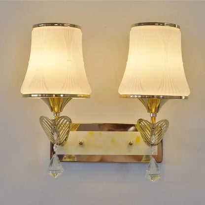 Modern gold crystal bedside wall sconce with frosted lampshades and heart-shaped accents for bedroom lighting