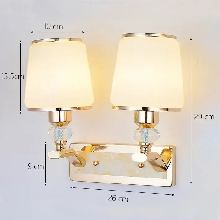 Modern gold crystal bedside wall sconce with double arms frosted cream lampshades and crystal bead accents