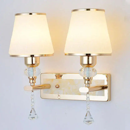 Modern gold crystal bedside wall sconce with cream fabric shades glass beads and crystal droplets for bedroom light