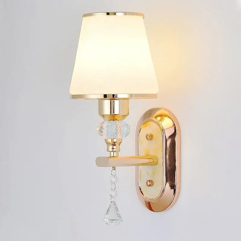 Modern gold crystal bedside wall sconce with cream fabric shade, crystal accents, and dangling glass beads for bedroom decorbites crystal bedside use