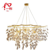 Modern gold crystal branch pendant chandelier featuring cascading crystal leaves on a branching metal frame for dining room decorbites crystal branch light