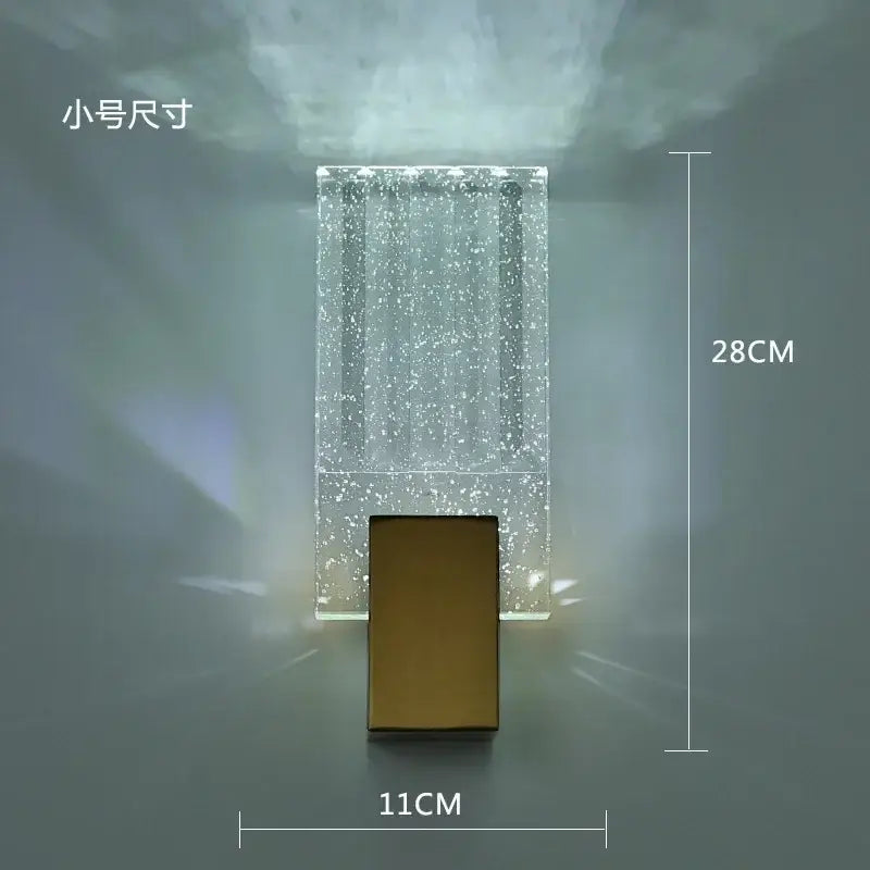 Modern wall lamp with a clear sparkling glass body and gold decorbites crystal brass led base for luxury decor