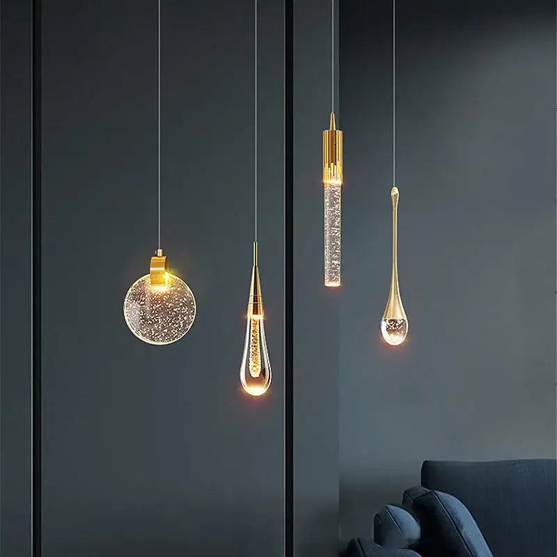 Modern gold crystal bubble pendant chandelier featuring sparkling glass shades in teardrop and circular shapes