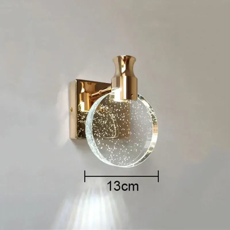 Modern gold crystal bubble wall lamp with clear glass globe and sparkling particles for luxury bedroom lighting decorbites wall lamp