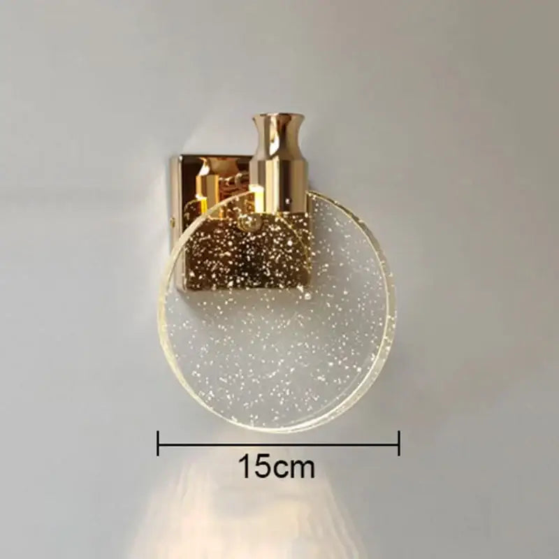 Modern gold crystal bubble wall lamp featuring a gold-toned sconce with a circular glittering glass shade decorbites crystal bubble