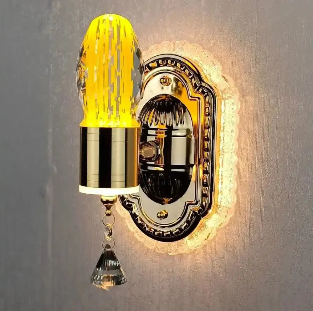 Modern gold crystal carved flower wall light featuring a gold-toned sconce with faceted yellow crystal shade and clear pendant