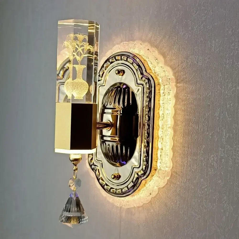 Modern gold wall light with decorbites carved flower design featuring crystal clear rectangular fixture and dangling crystals