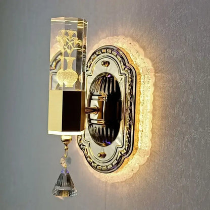 Modern gold wall light with decorbites carved flower design featuring crystal clear rectangular fixture and dangling crystals