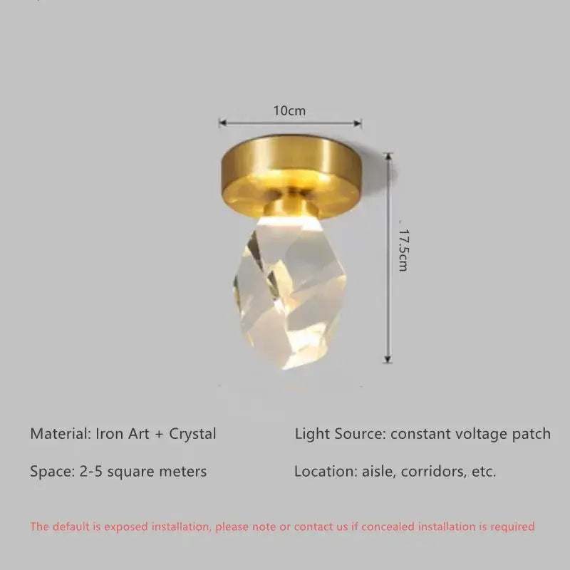 A modern gold crystal ceiling light with a brass-finished iron base and faceted clear crystal pendant