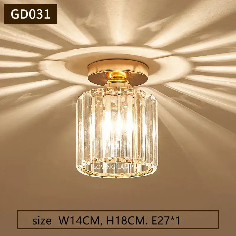 Modern gold crystal ceiling pendant light with gold-toned metal base and clear faceted glass panels for living room