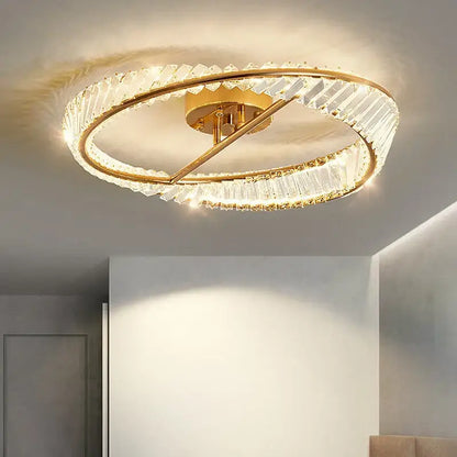Modern gold crystal ceiling pendant light featuring two concentric rings with faceted crystals for living room use