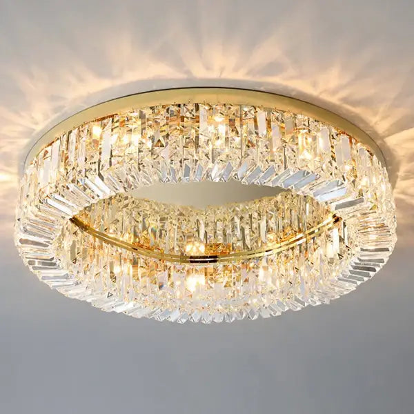 Modern gold crystal chandelier ceiling light featuring two concentric rings of faceted prisms in a gold frame
