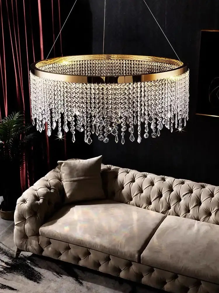 Modern gold crystal chandelier lighting fixture with cascading clear crystal droplets for elegant dining room decorbites decor