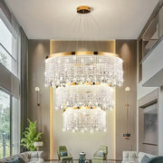 Modern gold crystal chandelier lighting fixture with cascading clear crystals and gold-finished frame for dining room decorbites crystal chandelier