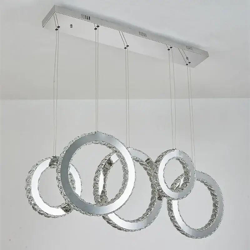 Modern chrome-finished pendant chandelier with interlocking crystal rings for elegant dining room decorbites crystal circle led lighting