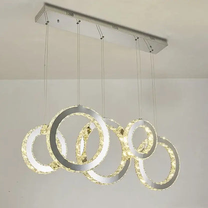 Modern chrome-finished pendant chandelier with interlocking crystal circle led rings for elegant dining room decorbites crystal circle