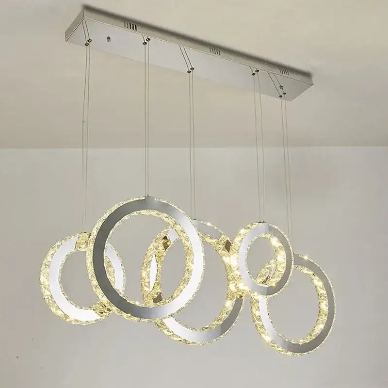 Modern chrome-finished pendant chandelier with interlocking crystal circle led rings for elegant dining room decorbites crystal circle
