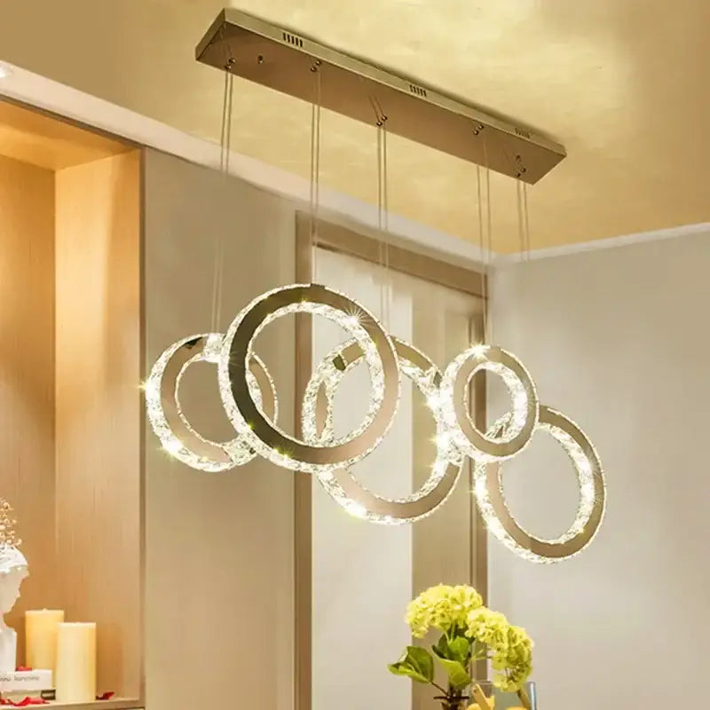 Modern gold pendant chandelier featuring interlocking decorbites crystal circle led rings for dining room decor