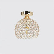 Modern gold crystal diamond ceiling light with spherical faceted crystals and gold-toned metal base for dining room