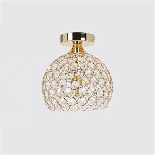 Modern gold crystal diamond ceiling light with spherical faceted crystals and gold-toned metal base for dining room