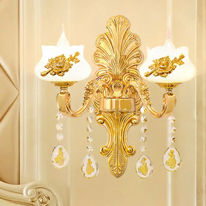 Modern gold crystal droplet wall mount light with two white glass shades and floral embellishments for bedroom use