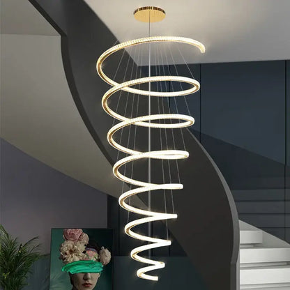 Modern gold crystal duplex ring pendant light with glowing spiral rings and sleek metallic gold-toned ceiling mount