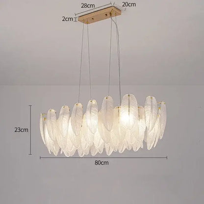 Modern gold crystal feather chandelier featuring an elegant white feather-shaped glass pendant with a gold ceiling mount