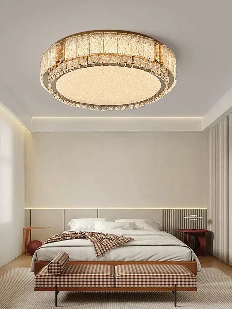 Modern gold light fixture with decorbites crystal glass tiers and illuminated central panel for living room decor
