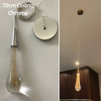 A 10cm chrome pendant light with a clear teardrop crystal glass led shade filled with golden glitter for dining room decorbites crystal glass