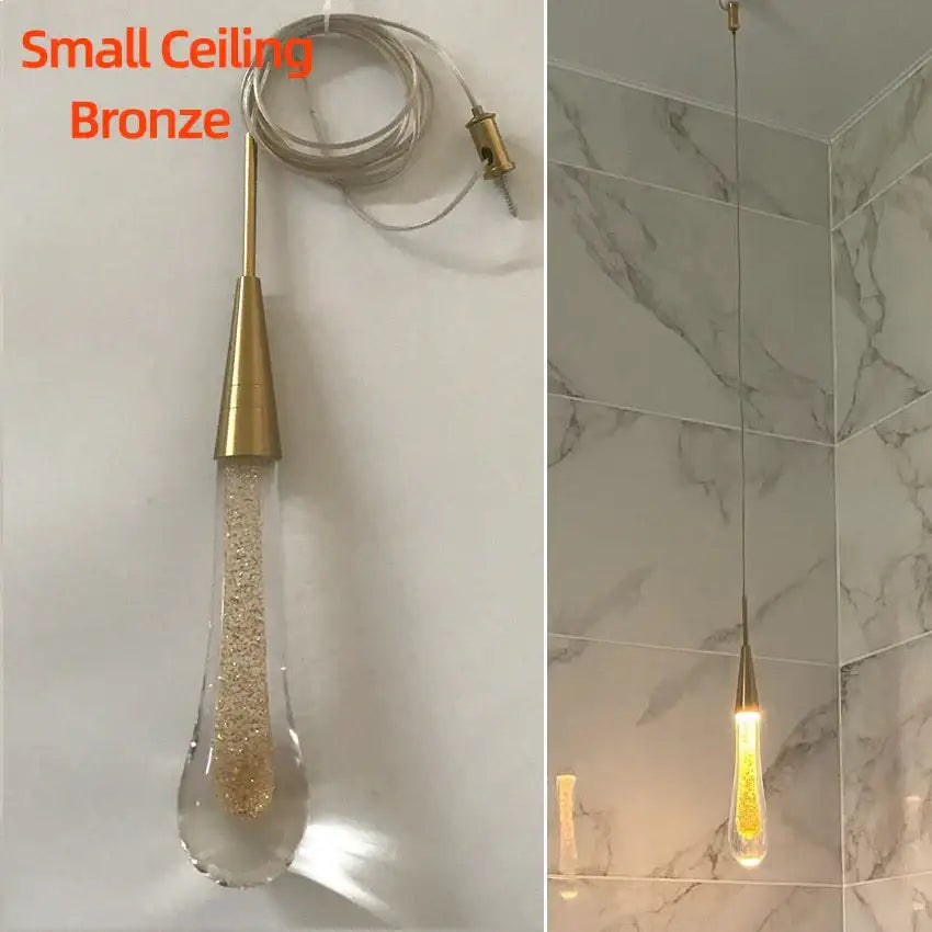A small bronze pendant light with teardrop decorbites crystal glass led shade filled with golden glitter for dining room