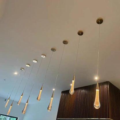 Modern gold crystal glass led pendant lights featuring a teardrop shape with brass accents for dining room decorbites crystal glass